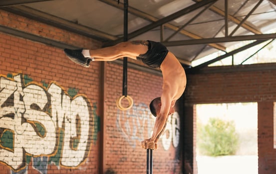 man athlete doing a mexican handstand. calisthenics photo