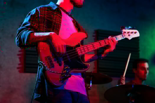 Bass Player In Stage With Colorful Lights photo