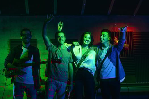 Musicians In Stage With Colorful Lights Performing In A Live Concert photo