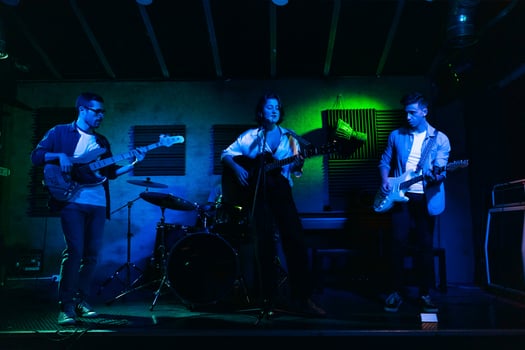 Musicians In Stage With Colorful Lights Performing In A Live Concert photo
