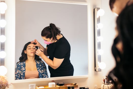 Professional makeup artist making up a young bride before the wedding photo