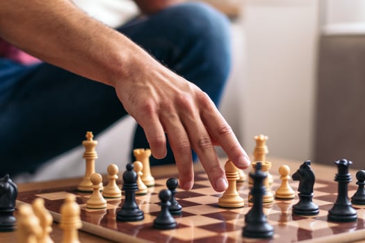 A person is playing chess on a table photo