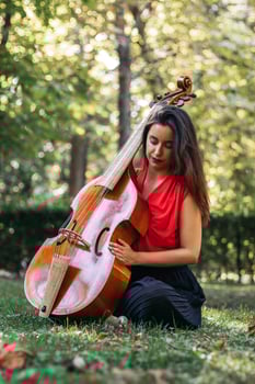 Woman with cello in a park photo