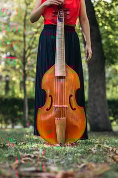 Female musician with her cello outdoors photo
