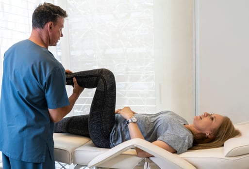 A woman getting her leg checked by a doctor photo
