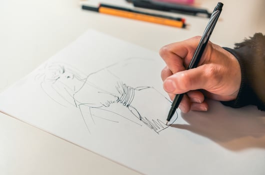 Close-up of a femaile desinger drawing with a pencil. photo