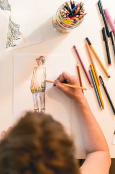 Top view of a fashion designer drawing a fashion sketch. Vertical shot photo