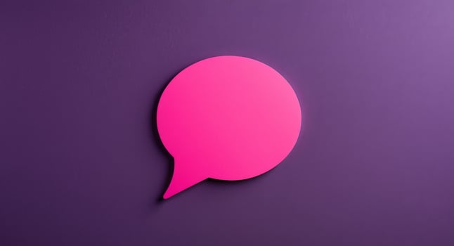 A pink speech bubble on a purple wall photo