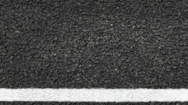 Close-up of asphalt road with single white line texture concept photo