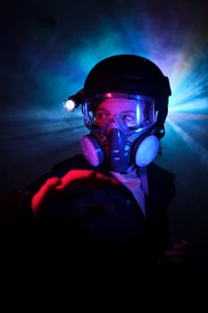 Boy in respirator observing dark mint during robbery photo