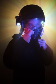 Boy in respirator with clenched fists photo