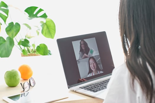 Asian doctor having chat with patient via laptop photo