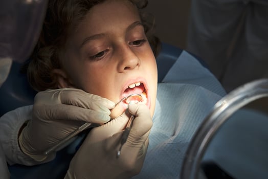 Boy undergoing dental treatment in clinic photo
