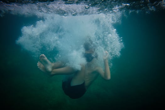 Boy underwater in clear sea photo