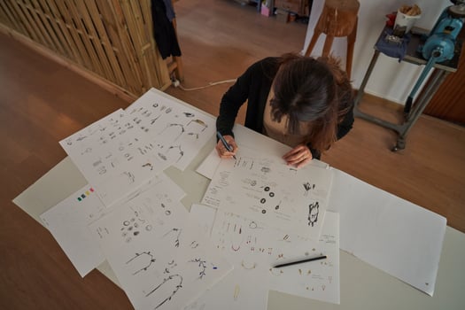 Female designer painting sketches on paper photo