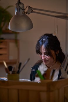 Concentrated woman working in jewelry workshop photo