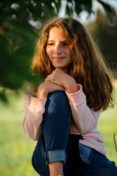 Girl resting under tree in nature photo