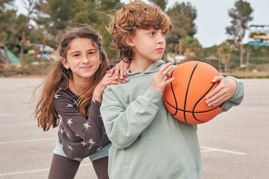 Carefree teenagers with basketball on street photo