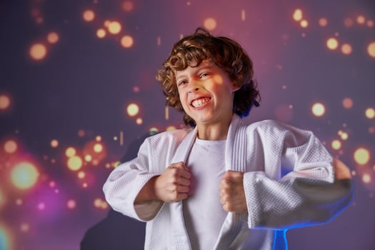 Martial boy in kimono practicing judo photo