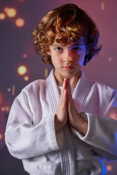 Boy in kimono doing greeting gesture photo