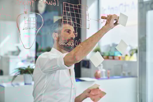 Concentrated worker with respirator writing on sticky notes photo