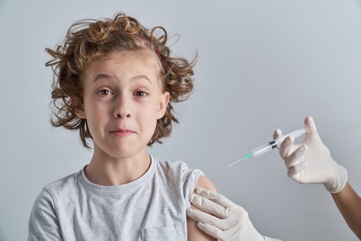 Curly child waiting for vaccine photo