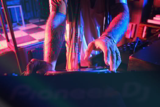 Unrecognizable DJ playing music in club photo