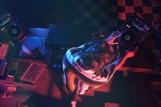 Anonymous DJ performing music in dark club photo