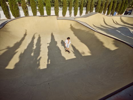 A young skateboarder riding a ramp at a skate park. photo