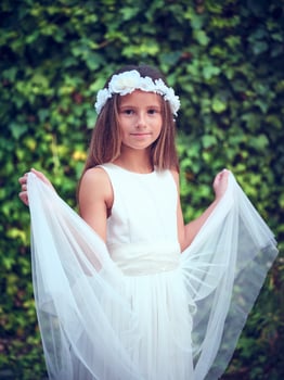 Charming girl in white dress and floral wreath against green bus photo