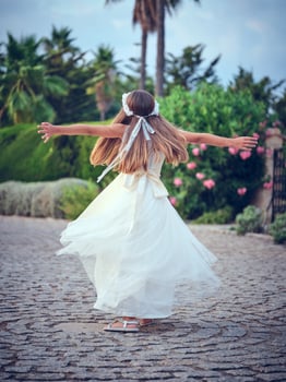 Anonymous girl in dress spinning around in park photo