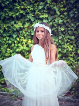 Happy girl in white dress smiling in summer park photo