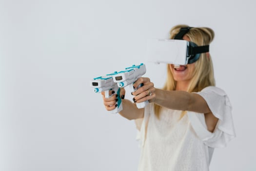 Woman in VR headset hving fun playing videogame photo