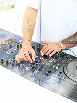 Crop DJ playing music on console photo