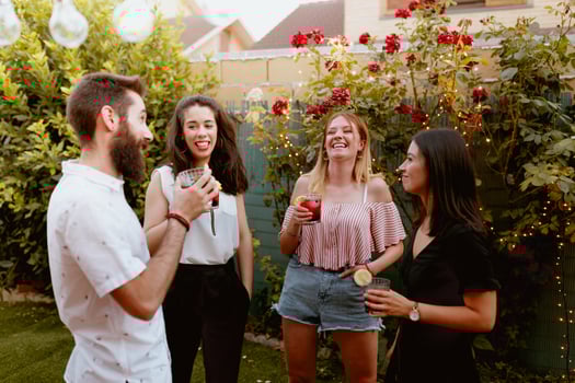 Four friends having a drink in the backyard photo