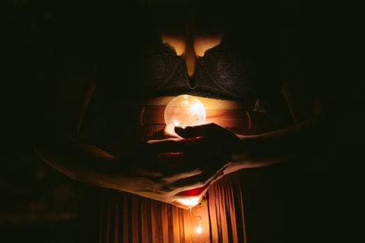 Faceless female with lightbulb in darkness photo
