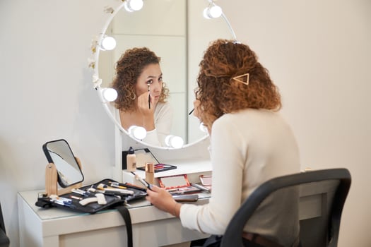 Concentrated woman doing makeup in beauty salon photo