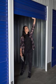 Positive woman opening door of storage photo