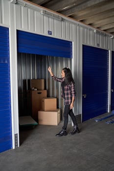 A woman is standing in a storage unit photo