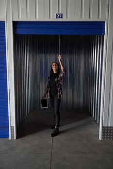 Woman opening metal self storage photo
