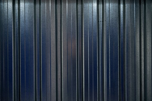 A metal wall with blue stripes. Background photo