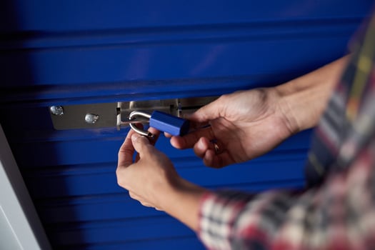 A person is opening a blue storage locker photo