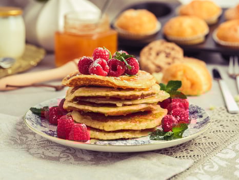 Palatable pancakes with berries served on table photo