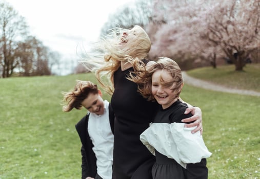 Three girls in black dresses and white shirts are having fun in the park photo