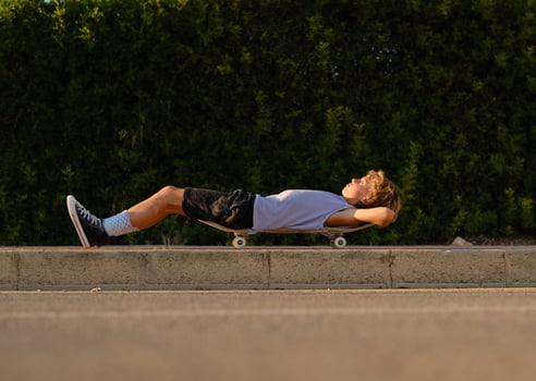 Carefree skater lying on skateboard in city photo