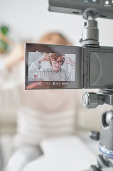 Crop boy recording on camera at home photo