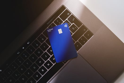 A credit card is sitting on top of a laptop photo
