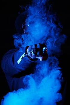Unrecognizable man punching through vapor photo