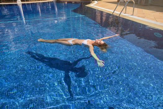 Female chilling while floating in pool water photo