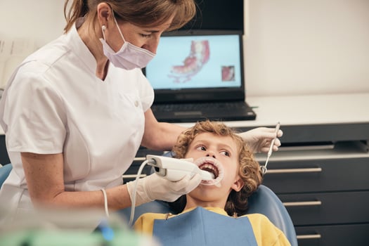 Dentist applying intraoral dental scanner for displaying casts of patient photo